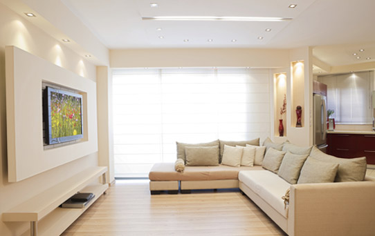Cream coloured living room with a TV